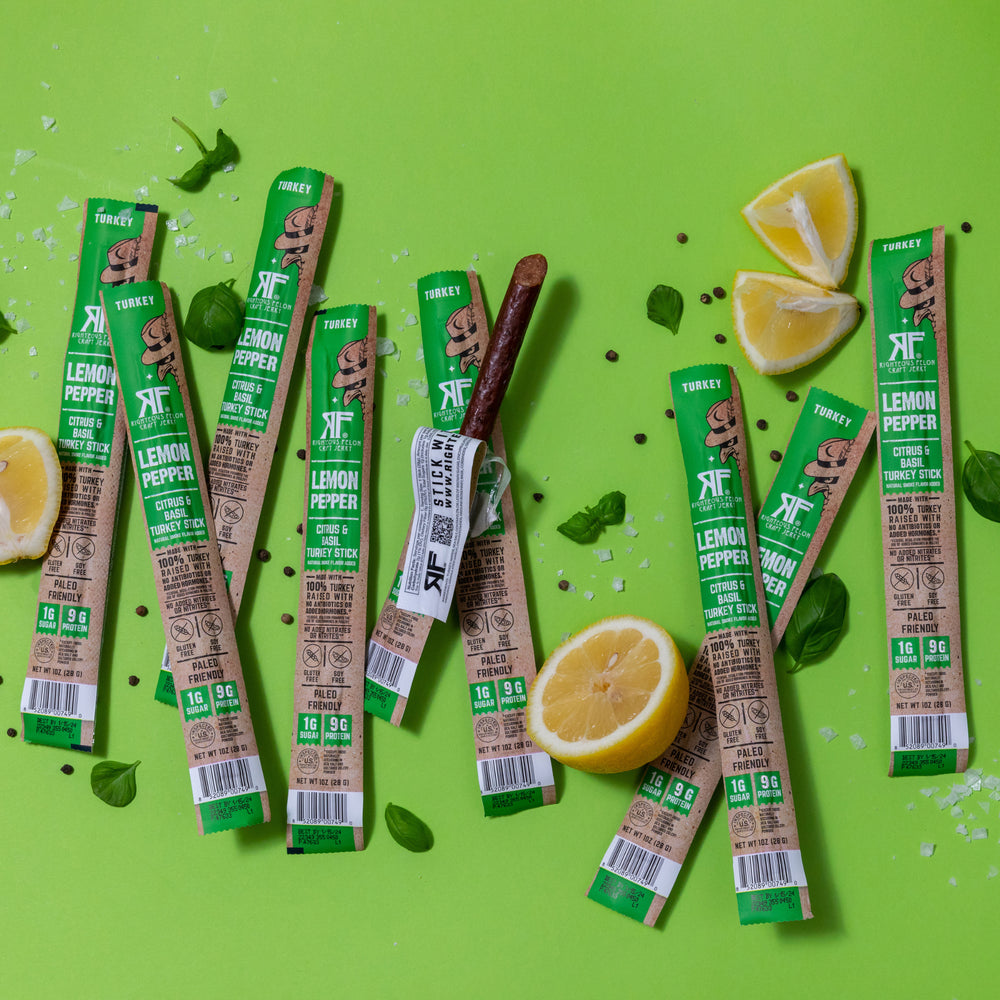 lemon pepper turkey sticks on green background with ingredients